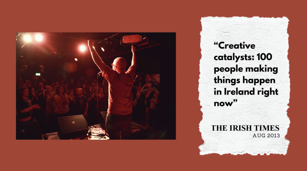 Kalle Ryan , back to camera, cheering to a crowd. Quotation: Creative Catalysts - 100 people making things happen in Ireland right now